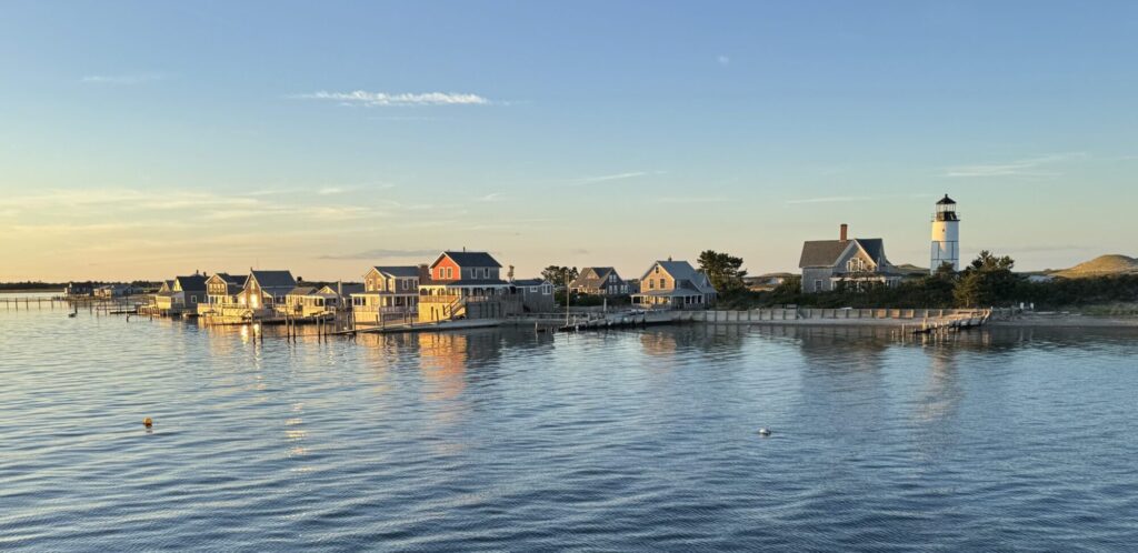 Magic hour dusk picture of Sandy Neck Lighthouse and neighboring cottages
